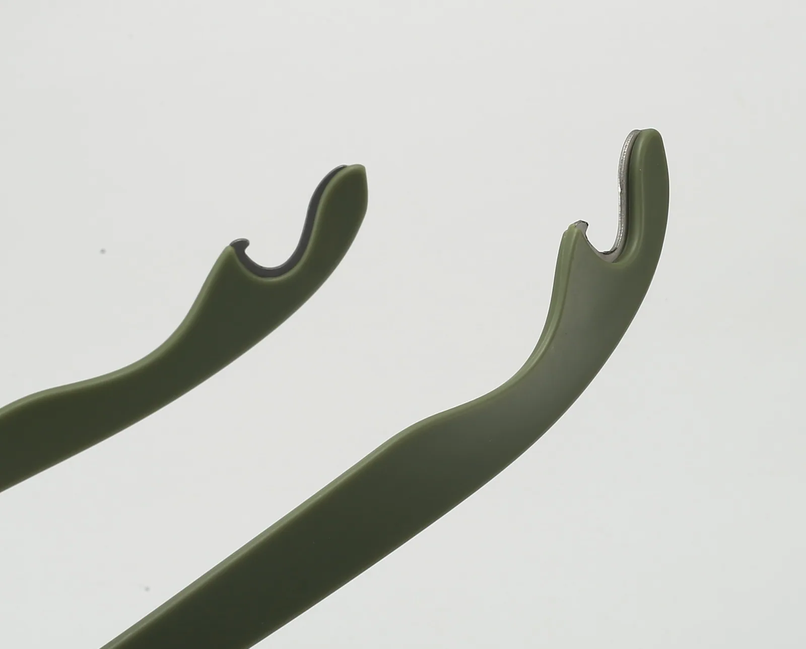 Metal bottle-opener inserts embedded in the ends of sunglasses temples