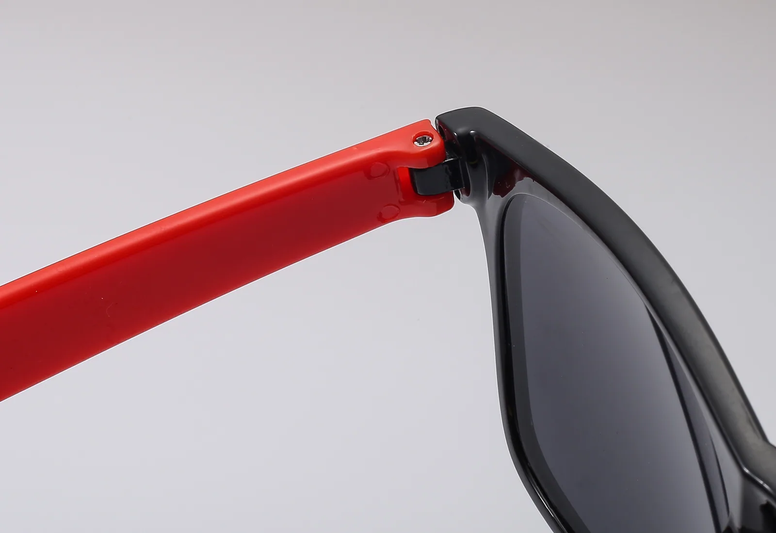 Close view of the hinge connection on bottle-opener sunglasses